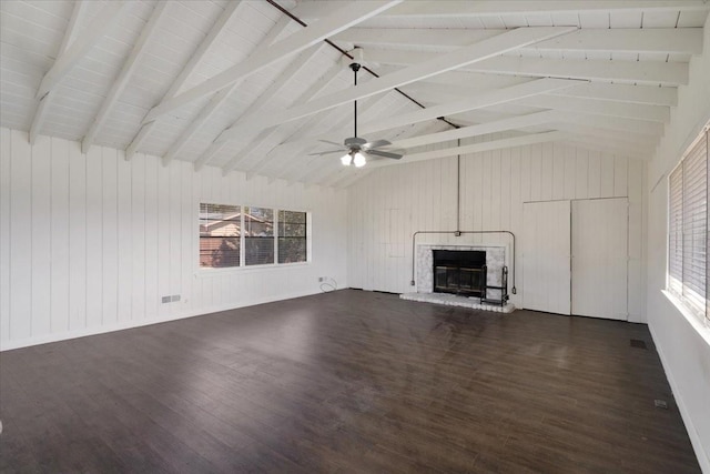 unfurnished living room featuring a glass covered fireplace, lofted ceiling with beams, and dark wood-type flooring