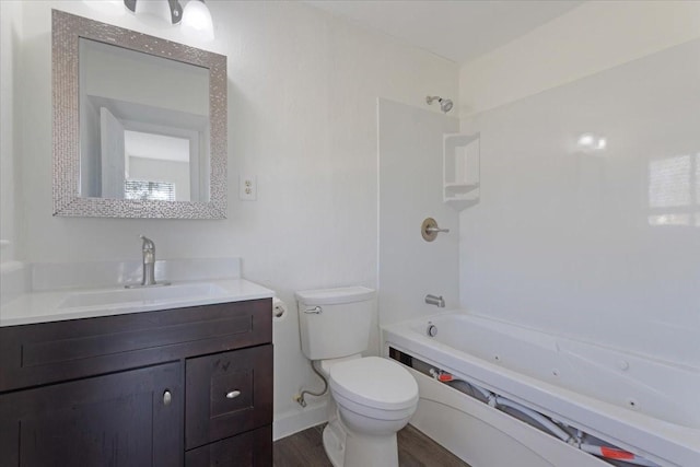 bathroom featuring vanity, toilet, shower / bathtub combination, and wood finished floors