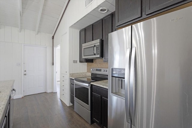 kitchen with light stone counters, visible vents, lofted ceiling with beams, stainless steel appliances, and dark wood-type flooring