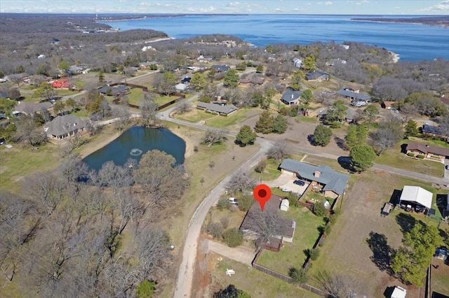 bird's eye view featuring a water view and a residential view