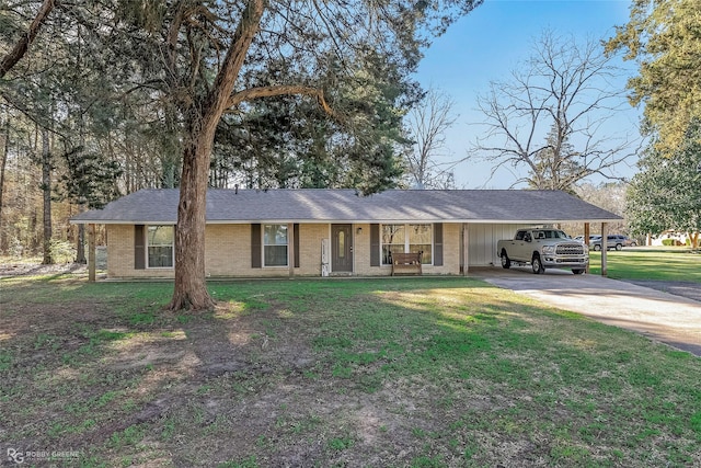 ranch-style house with brick siding, driveway, a front lawn, and a carport