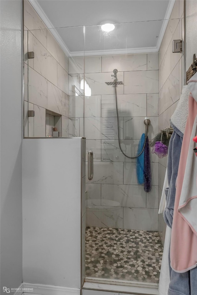 full bath with a stall shower and ornamental molding