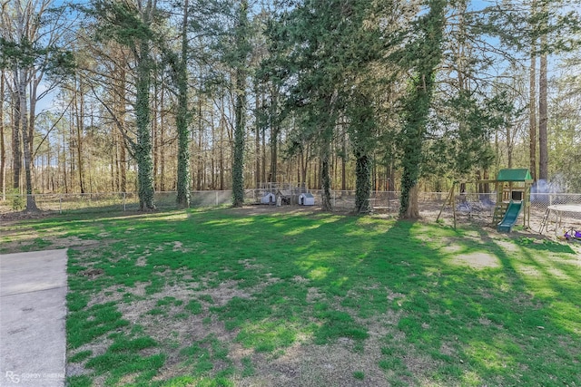 view of yard featuring a playground and a fenced backyard