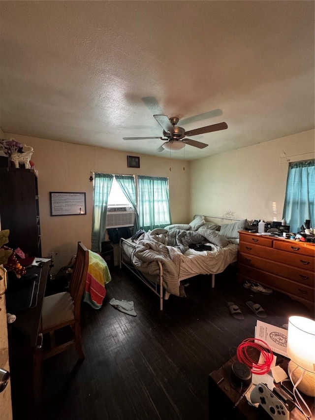 bedroom with cooling unit, a textured ceiling, ceiling fan, and wood-type flooring