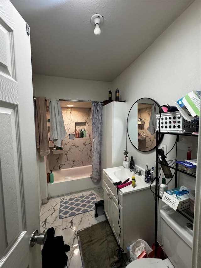 full bath with toilet, marble finish floor, and vanity