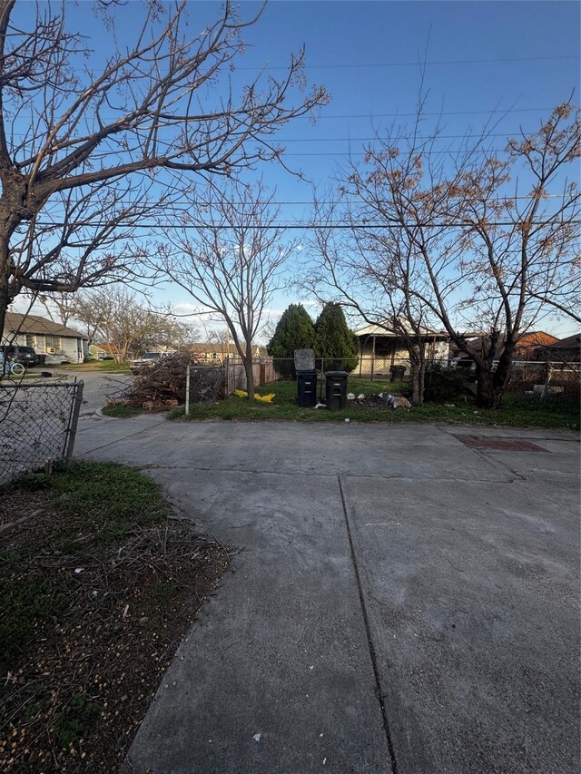 view of road featuring concrete driveway