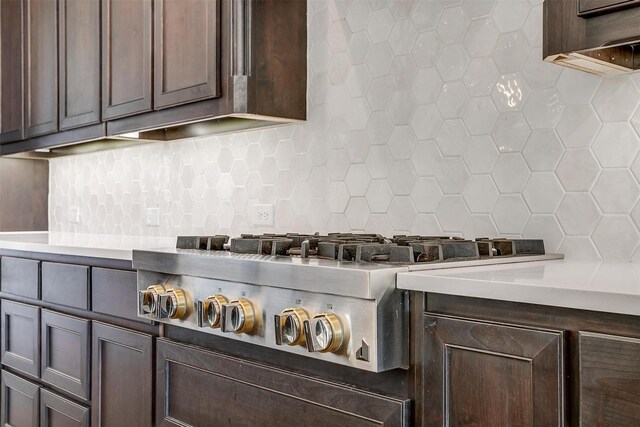 kitchen featuring dark brown cabinetry, backsplash, stainless steel gas cooktop, and light countertops