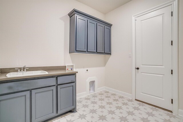 laundry area with hookup for a washing machine, light floors, cabinet space, electric dryer hookup, and a sink