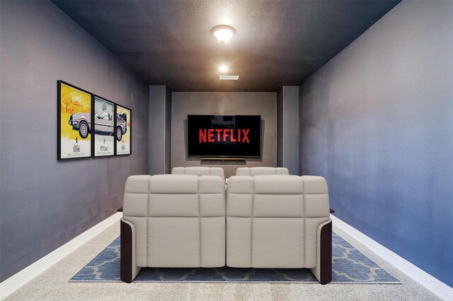 unfurnished room featuring visible vents, light carpet, a textured ceiling, and baseboards