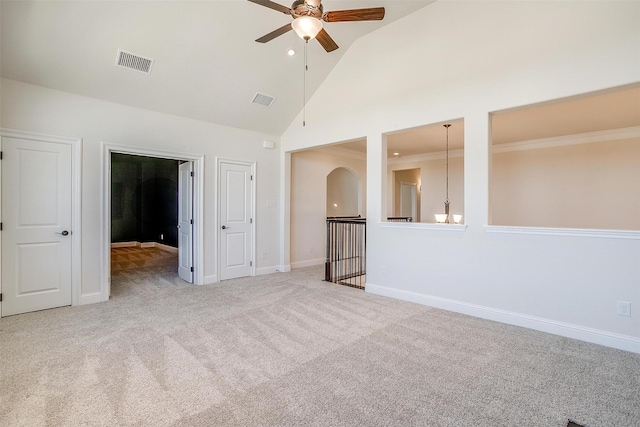 unfurnished room with high vaulted ceiling, light colored carpet, visible vents, and baseboards