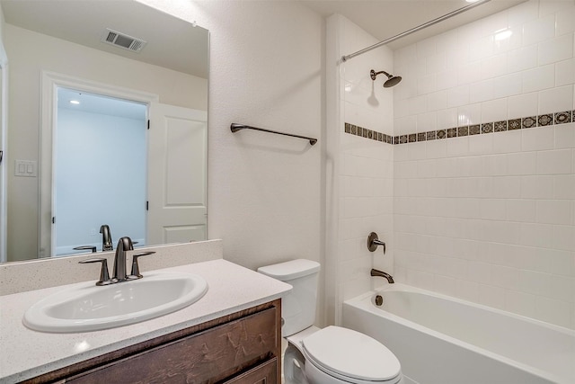 full bathroom featuring visible vents, toilet, vanity, and shower / tub combination