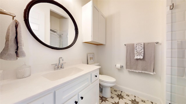 full bathroom featuring tile patterned floors, toilet, baseboards, walk in shower, and vanity