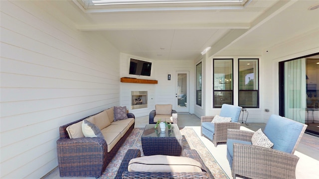 view of patio featuring an outdoor living space with a fireplace