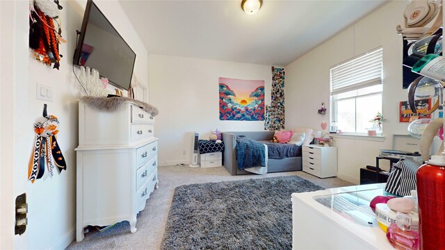 bedroom featuring baseboards and light carpet