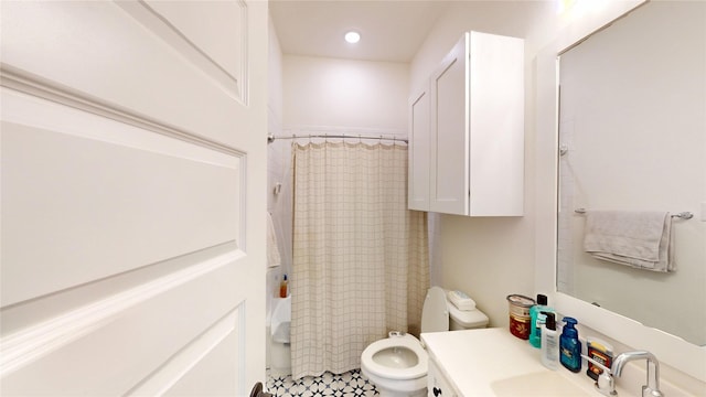 bathroom featuring vanity, toilet, and a shower with curtain