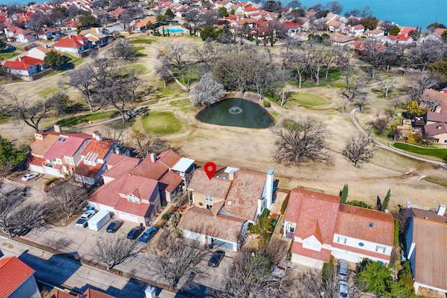 birds eye view of property featuring view of golf course, a residential view, and a water view