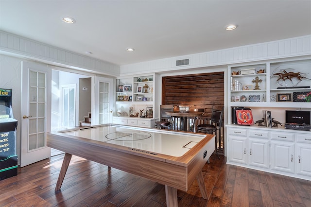 rec room featuring built in features, visible vents, recessed lighting, dark wood-type flooring, and french doors