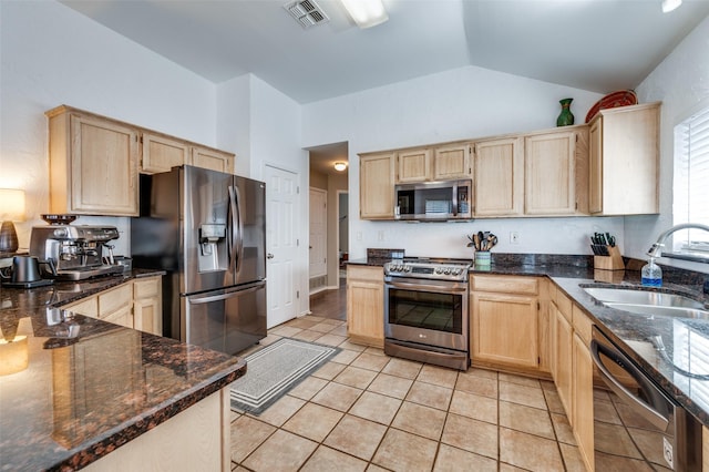 kitchen featuring a sink, light brown cabinetry, and stainless steel appliances