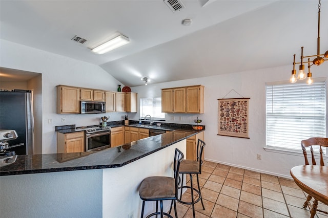 kitchen with visible vents, appliances with stainless steel finishes, a peninsula, light tile patterned floors, and lofted ceiling