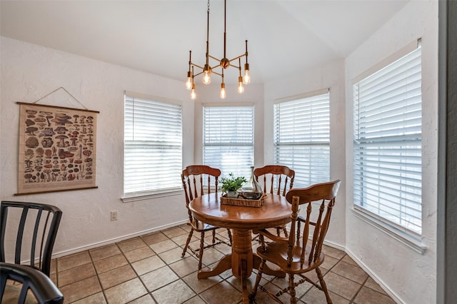 tiled dining room featuring a wealth of natural light, baseboards, and a textured wall