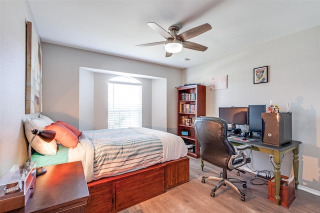 bedroom with a ceiling fan and wood finished floors