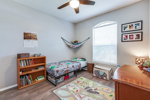 bedroom with a ceiling fan and wood finished floors