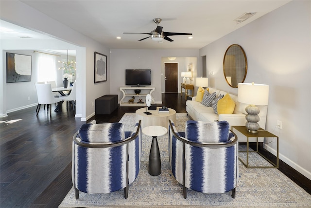 living area featuring visible vents, baseboards, and wood finished floors