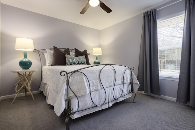 carpeted bedroom with ceiling fan and baseboards