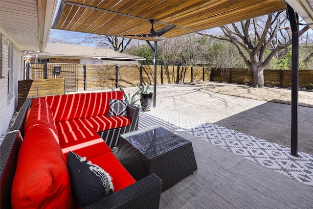 view of patio with a ceiling fan, an outdoor living space, and a fenced backyard