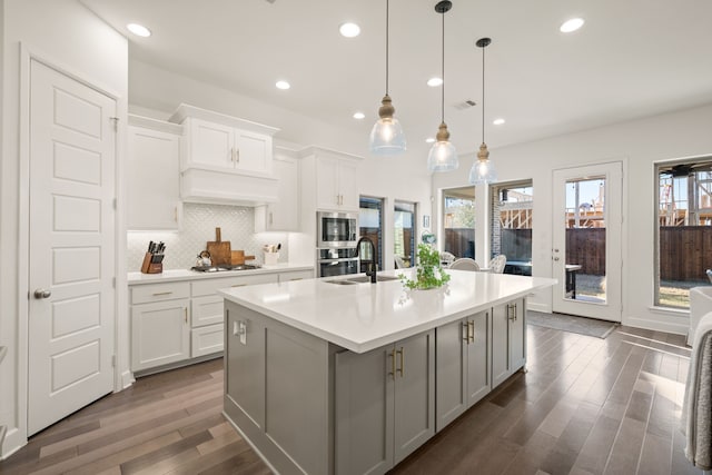 kitchen with visible vents, a healthy amount of sunlight, gray cabinets, stainless steel appliances, and a sink