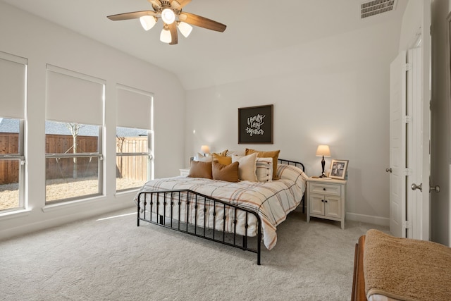 bedroom featuring a ceiling fan, visible vents, baseboards, lofted ceiling, and light colored carpet