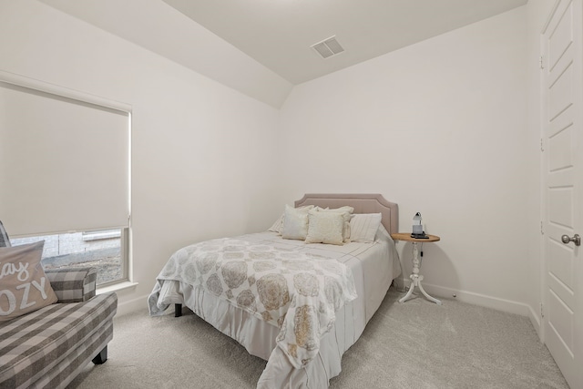 carpeted bedroom featuring visible vents, baseboards, and vaulted ceiling