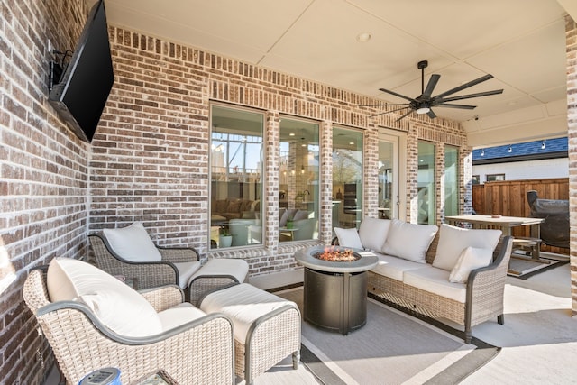 view of patio with an outdoor living space with a fire pit, ceiling fan, and fence