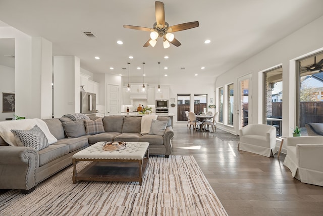 living room featuring plenty of natural light, recessed lighting, visible vents, and ceiling fan