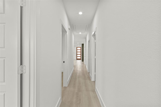 hallway featuring recessed lighting, baseboards, attic access, and light wood-style flooring