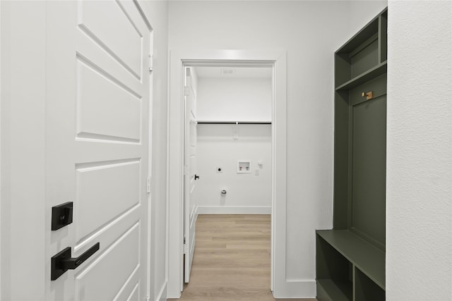 mudroom with light wood-style flooring and baseboards