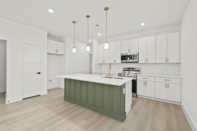 kitchen featuring visible vents, a sink, light countertops, white cabinets, and appliances with stainless steel finishes