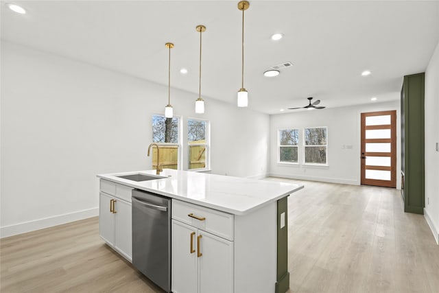 kitchen featuring stainless steel dishwasher, light wood-type flooring, visible vents, and a sink