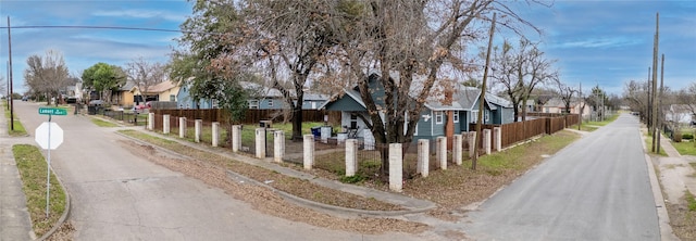 view of street with sidewalks, traffic signs, and a residential view