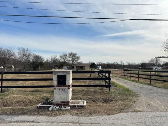 exterior space featuring a rural view and fence