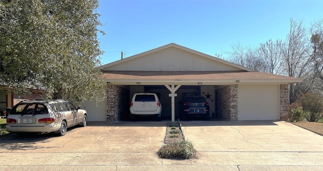 view of front of property with brick siding, driveway, and a garage