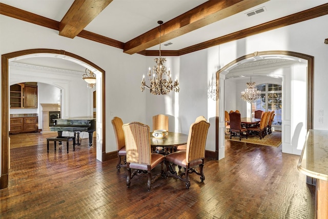 dining area with beamed ceiling, a notable chandelier, visible vents, and arched walkways