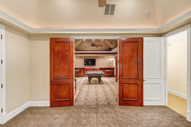 interior space with visible vents, baseboards, carpet, and ornamental molding