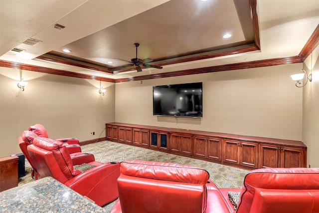 home theater with baseboards, recessed lighting, ornamental molding, ceiling fan, and a raised ceiling