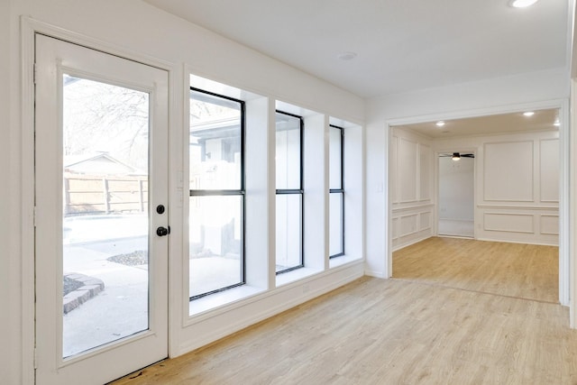 spare room featuring recessed lighting, a healthy amount of sunlight, and light wood-style flooring