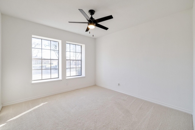 unfurnished room featuring baseboards, carpet, and ceiling fan