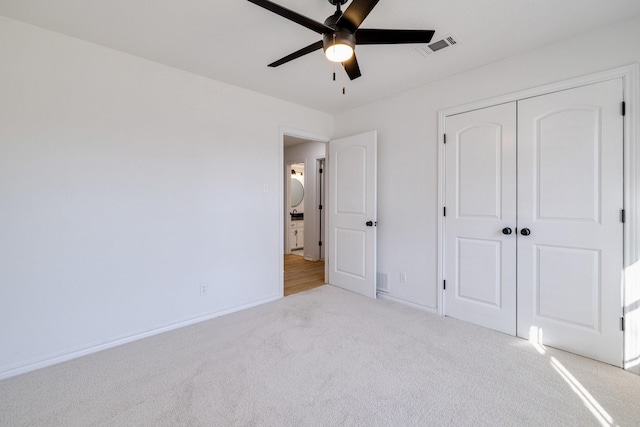 unfurnished bedroom with a ceiling fan, visible vents, carpet, baseboards, and a closet