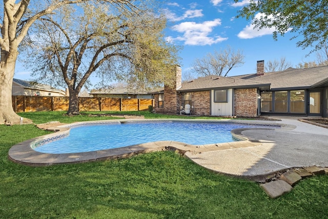 view of swimming pool featuring a patio area, a fenced in pool, a yard, and fence