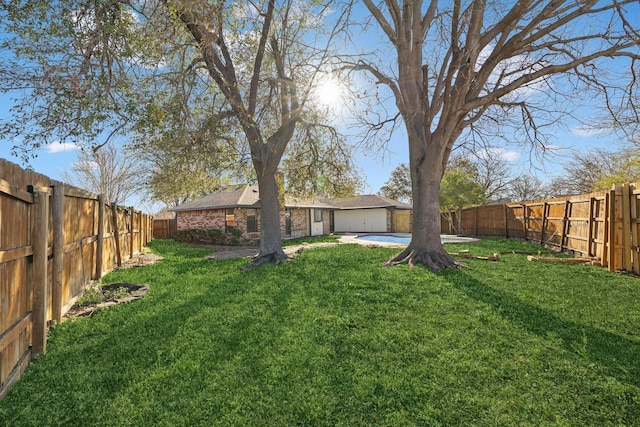 view of yard with a swimming pool and a fenced backyard