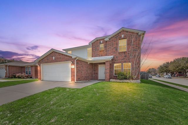 traditional home with a front yard, brick siding, a garage, and driveway